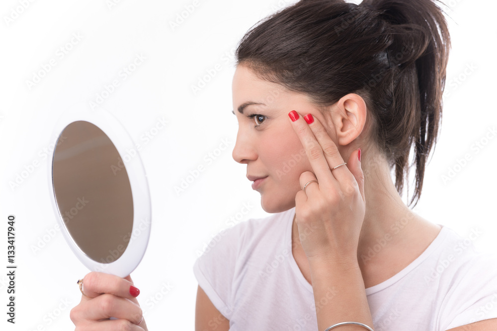Woman Looking At Herself In The Mirror. Isolated on white. Woman Looking At Herself In The Mirror. Isolated on white.