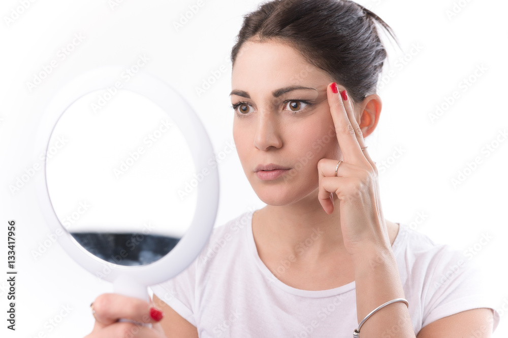 Woman Looking At Herself In The Mirror. Isolated on white. Woman Looking At Herself In The Mirror. Isolated on white.