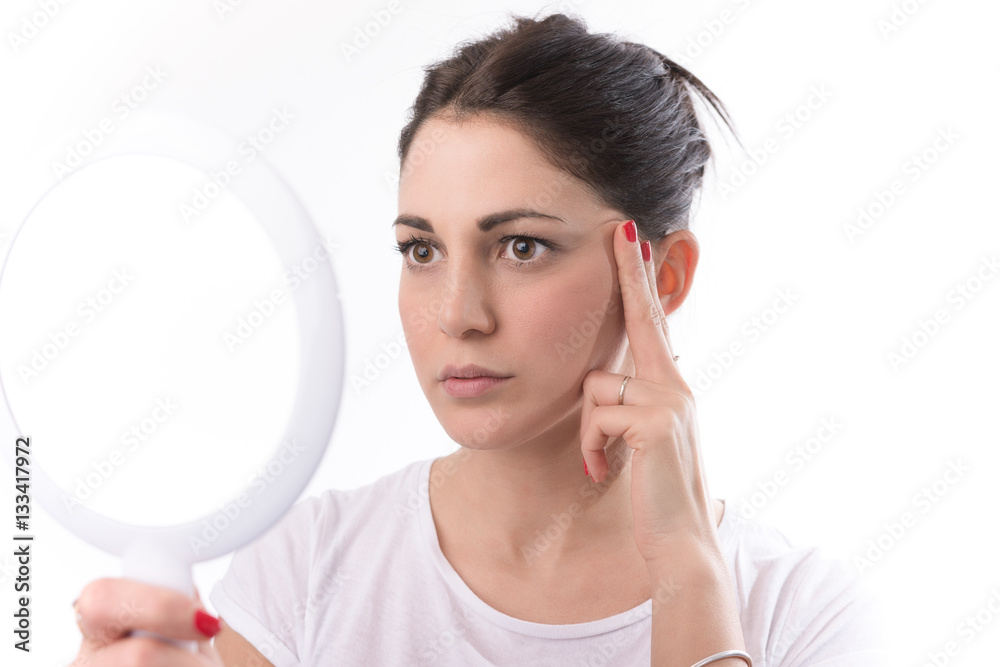 Woman Looking At Herself In The Mirror. Isolated on white. Woman Looking At Herself In The Mirror. Isolated on white.