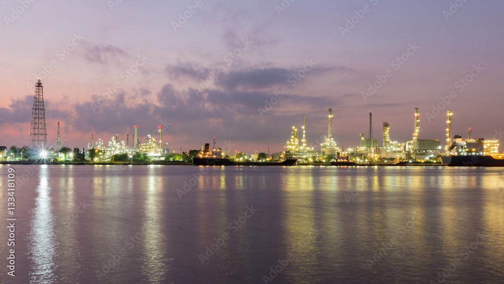 Obraz premium Panorama Oil refinery river front after sunset, industrial landscape background