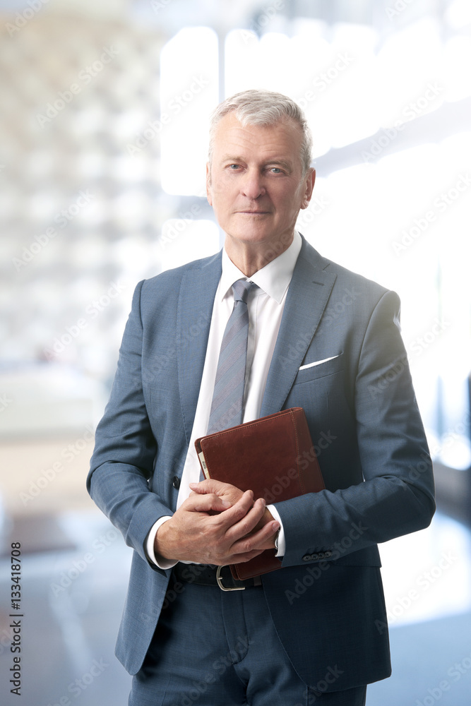 Fototapeta premium Senior businessman standing at office
