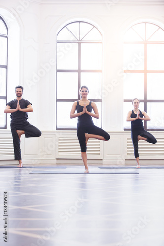 Group of young people doing yoga in the class