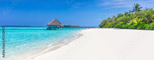 Panorama of wide sandy beach on a tropical island in Maldives