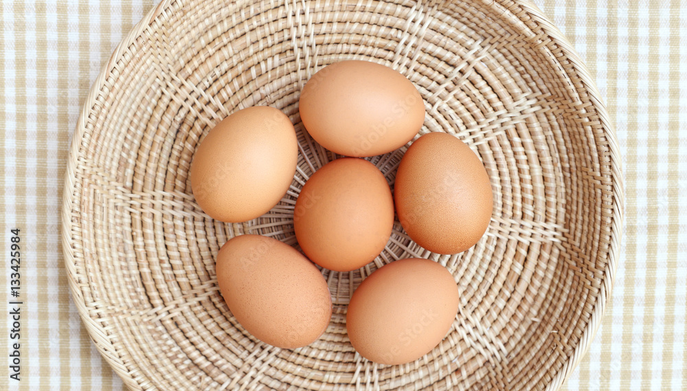 Eggs Chicken on wooden basket in the center frame 2 Eggs Chicken on wooden basket in the center frame 2