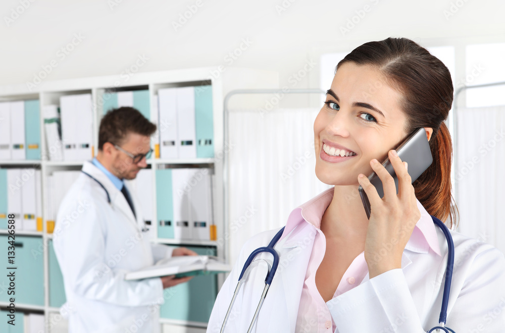 Doctor smiling on the phone, concept of medical booking Doctor smiling on the phone, concept of medical booking