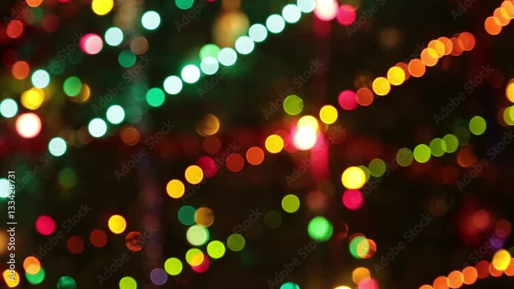 Christmas tree with colorful bokeh and christmas lights..Christmas and new year decoration. Abstract bokeh holiday background. Blinking garland. Christmas lights twinkling.