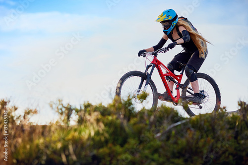 Woman riding MTB mountain biking, cross-country