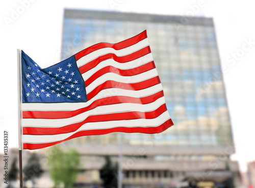 American flag on blurred building background photo