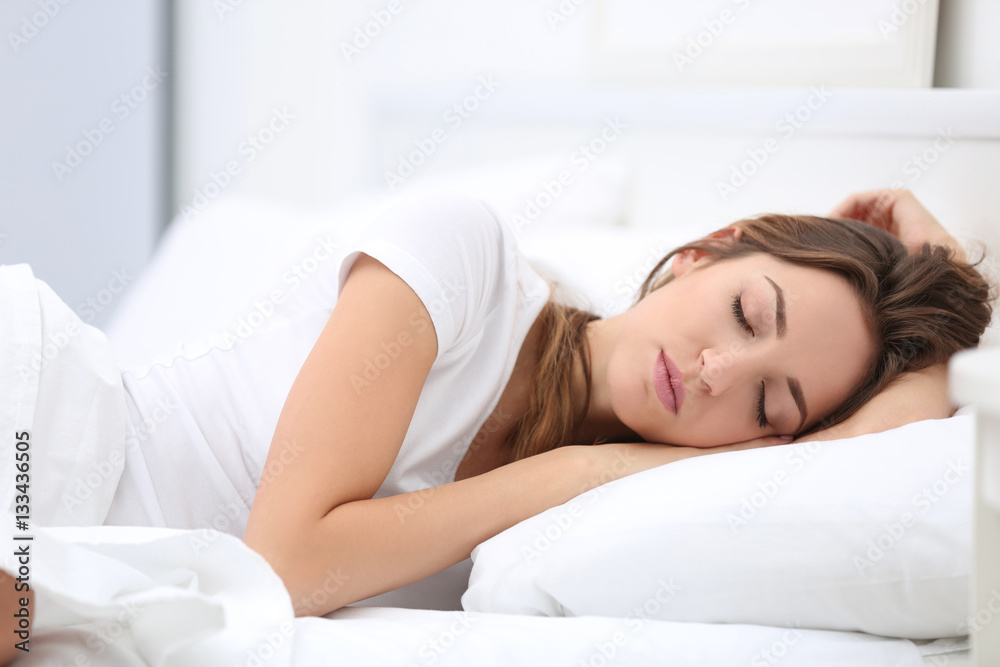 Young attractive woman sleeping in bed at home - obrazy, fototapety, plakaty 