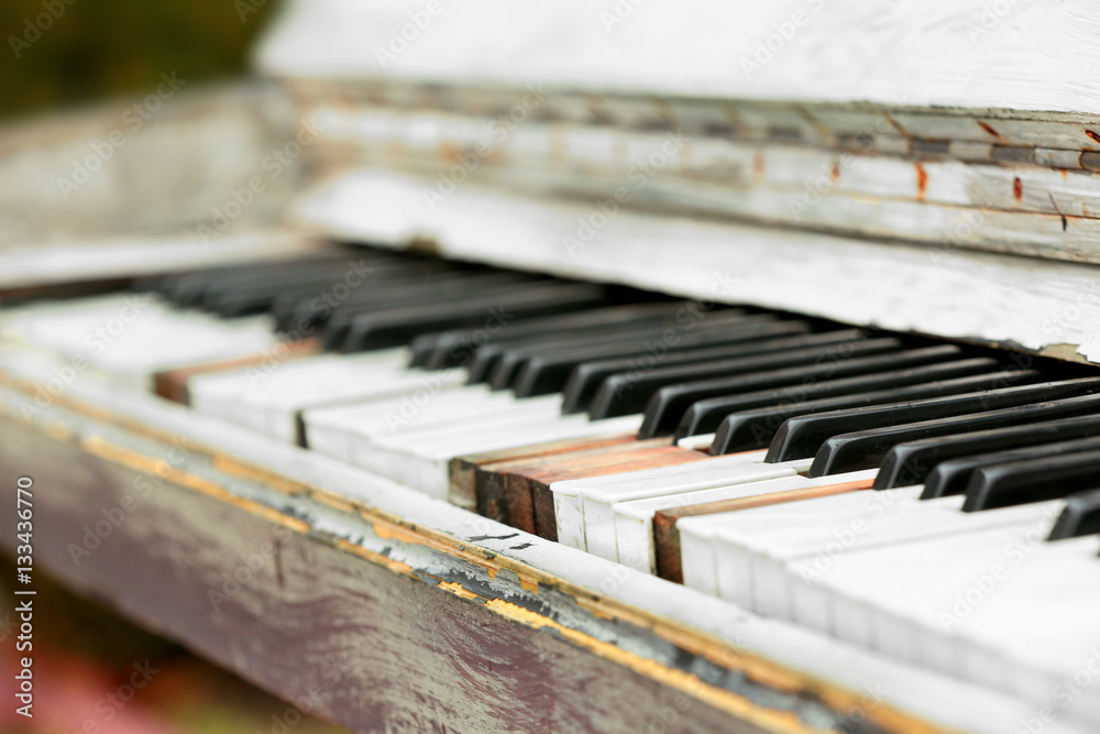 Closeup of old damaged piano keyboard