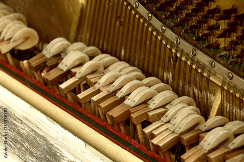 Closeup of old damaged piano  view from inside