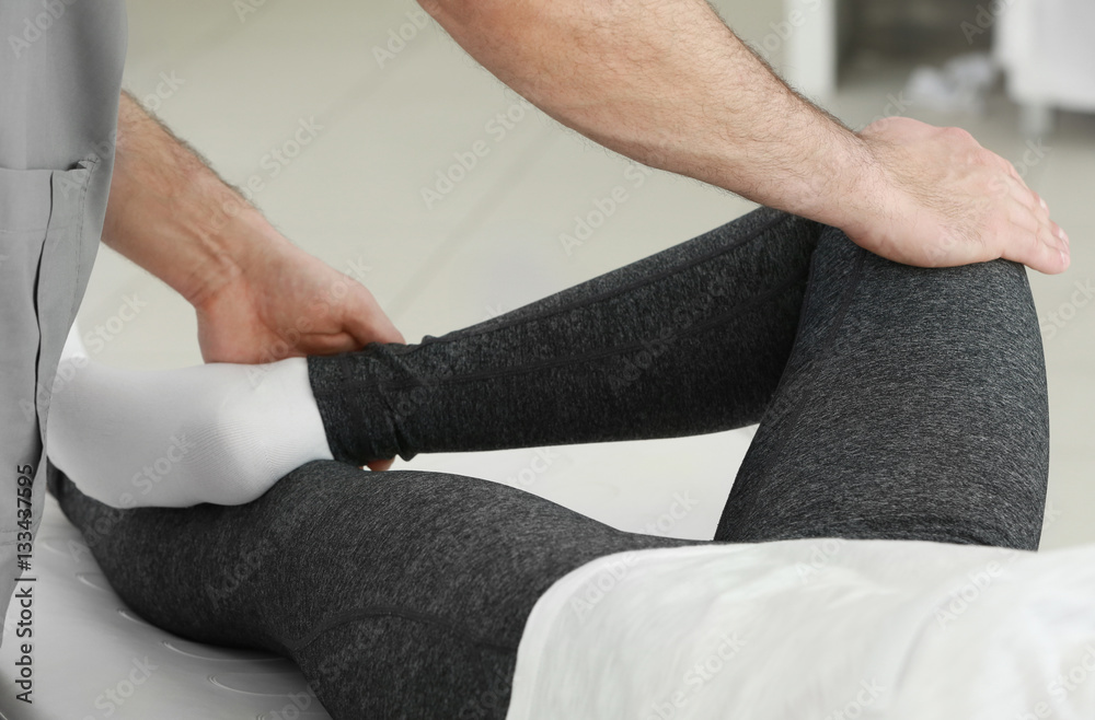 Physiotherapist working with patient in clinic, closeup