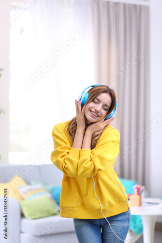 Beautiful young woman liste...