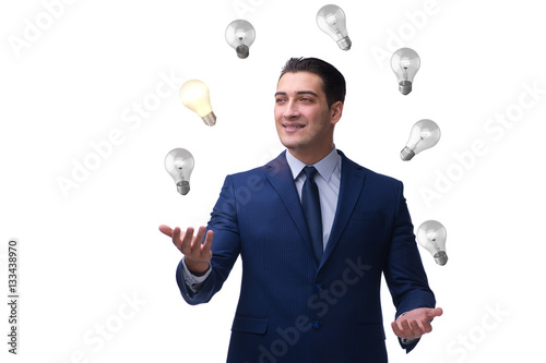 Businessman juggling lightbulbs in new idea concept