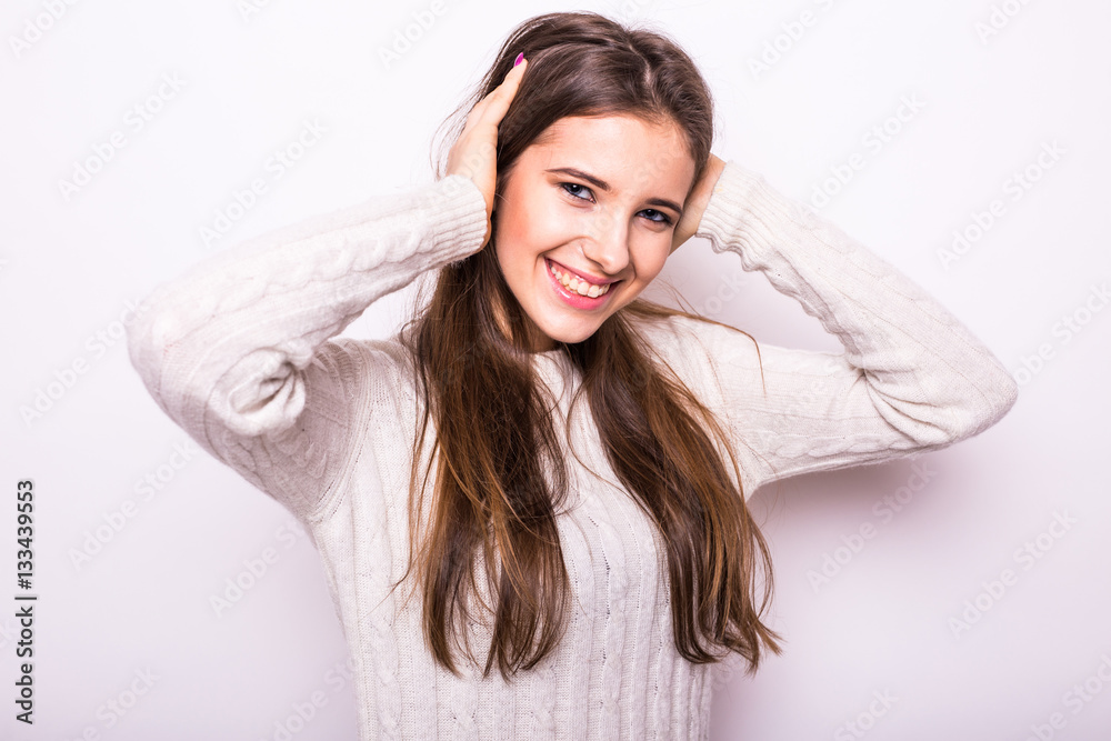 Portrait of young fashion girl in white sweater on white Portrait of young fashion girl in white sweater on white