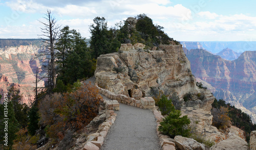 Path to bright angel vista point in Grand Canyon National Park landscape from north rim on a cloudy sky photo