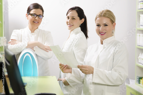 Group of young  beautiful female pharmacists  selective focus on blonde woman 