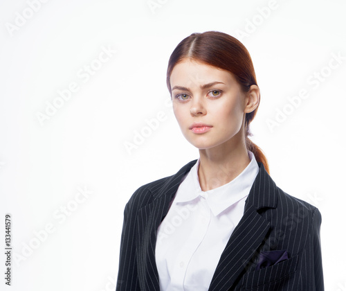 confident woman in a dark jacket and in a shirt, leader