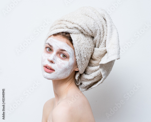  cream on her face  mask on the face  a towel on his head  problem skin