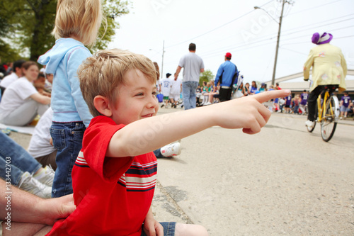 Boy watching a parade, photo