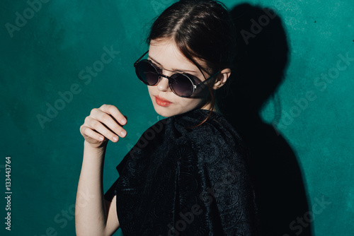 woman with glasses on a blue background