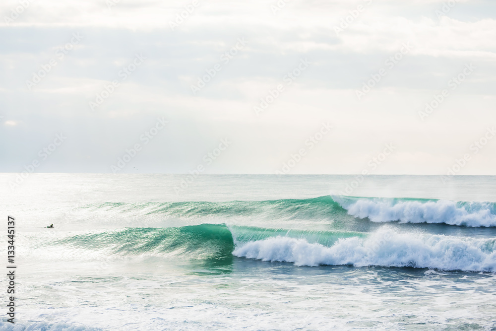 Green waves in ocean. Sunny day