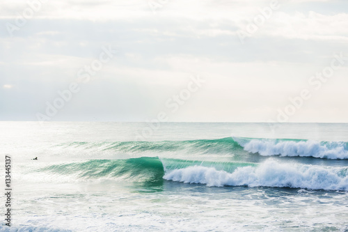 Green waves in ocean. Sunny day