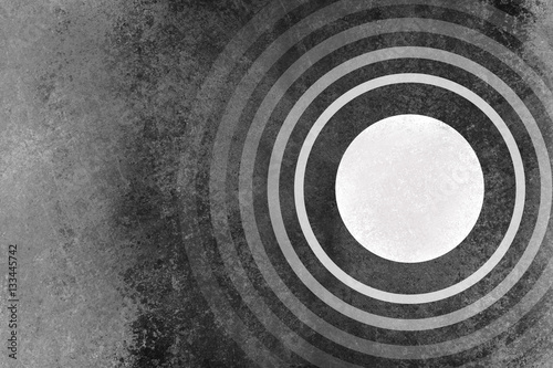 rings of white circle shapes on black and gray grunge background