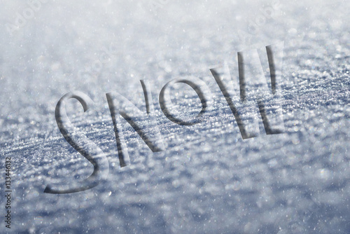 icy surface of a glass during the winter with snow written