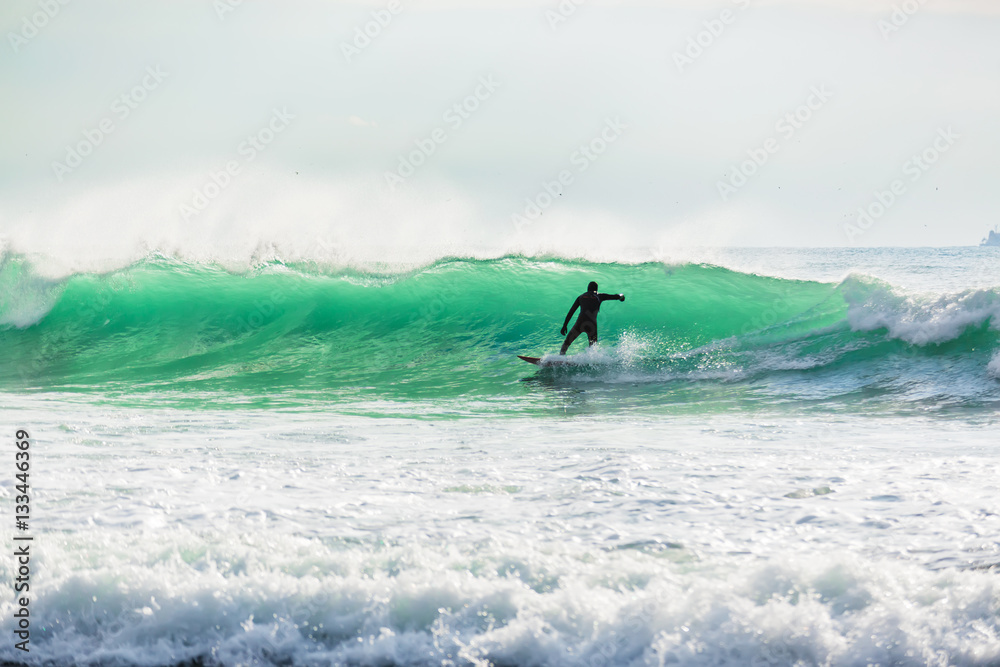 Surfing on turquoise wave in ocean. Close out