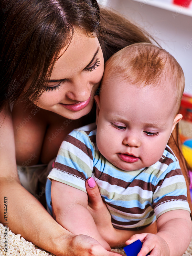 Mother and child playing . Baby boy with mama have fun at home. Family portrait mom and kid son