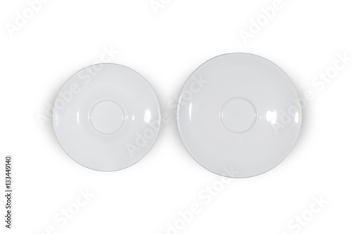 Two flat white saucers side by side smaller and bigger on white background directly from above