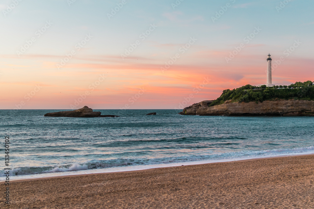 Lighthouse at the sea during sunset