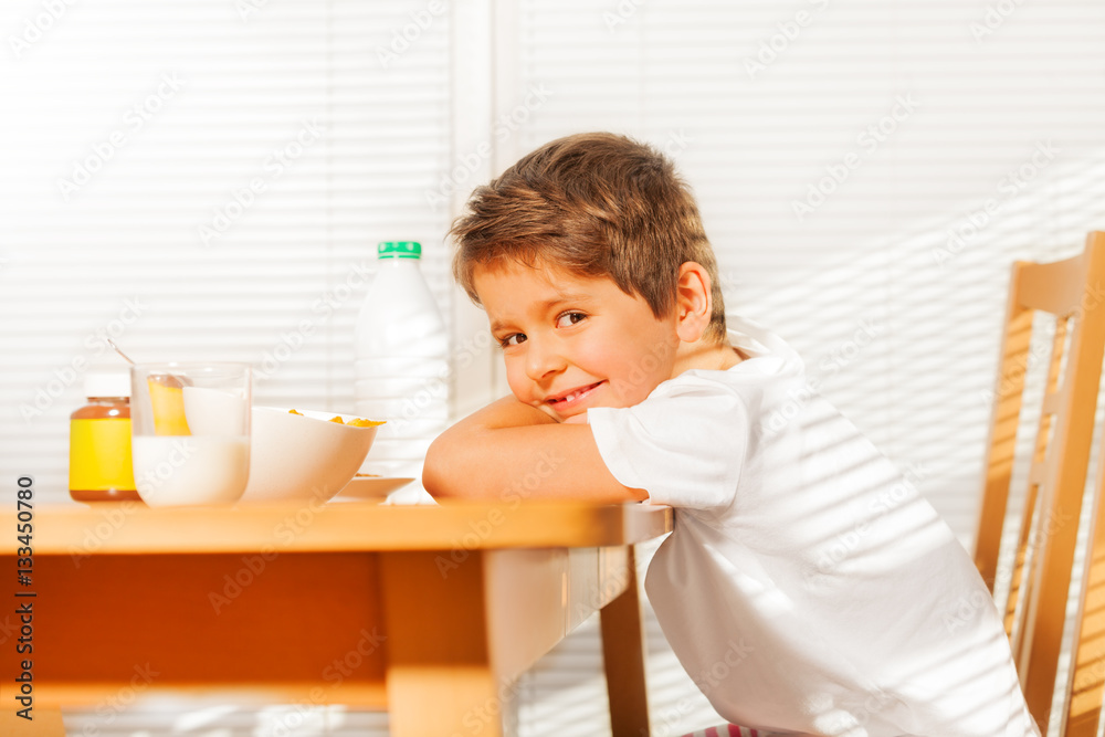 Boy sitting at table during breakfast in kitchen Boy sitting at table during breakfast in kitchen