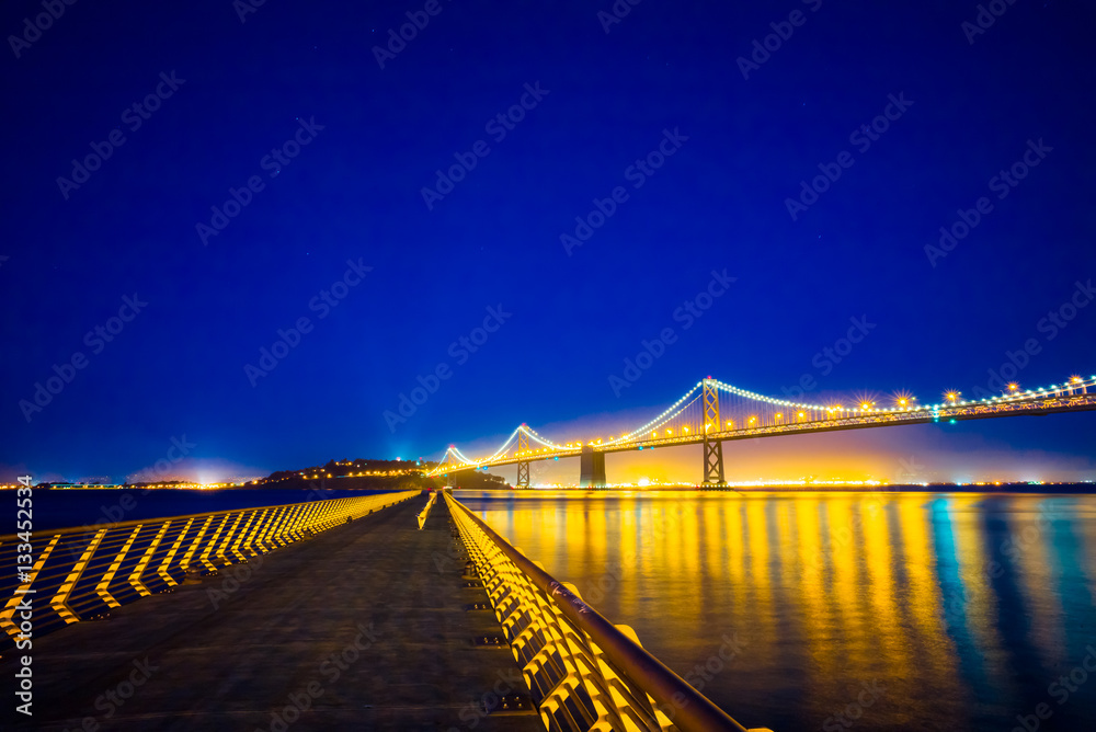 Fototapeta premium San Francisco Bay Bridge from Pier 14 at night with street lights