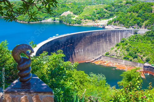 Lake Kariba dam wall and a statue of nyami nyami the river snake god.  Zambezi river.  Zimbabwe Africa.