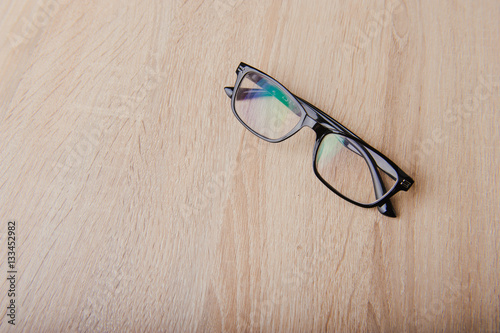 Clear Eyeglasses Glasses with Black Frame Fashion Vintage Style on Wood Desk