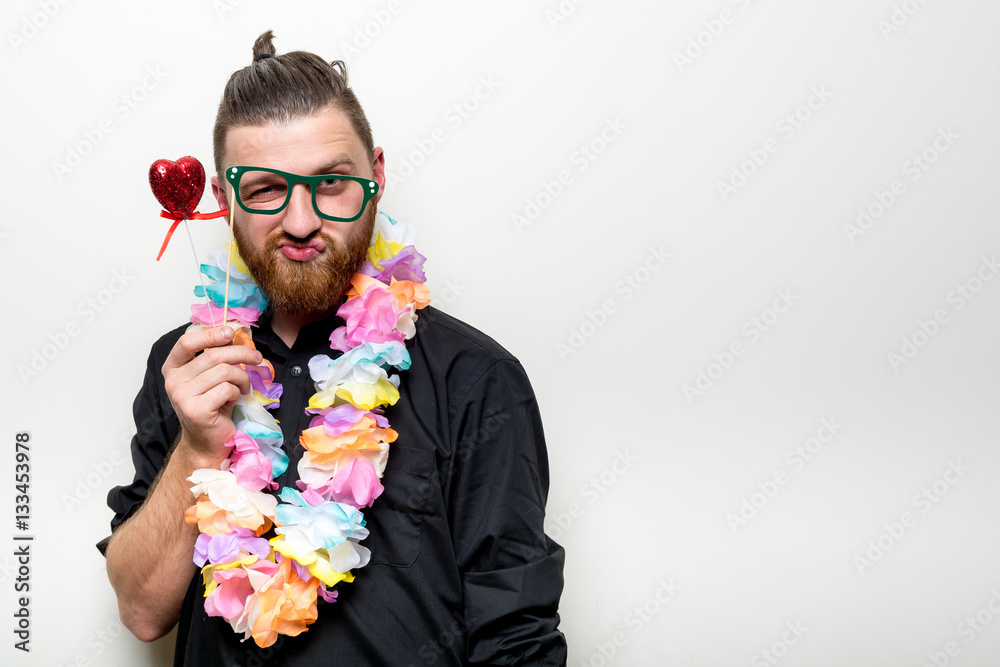 young man and baby happy smile posing on white background with party accessory props photo booth