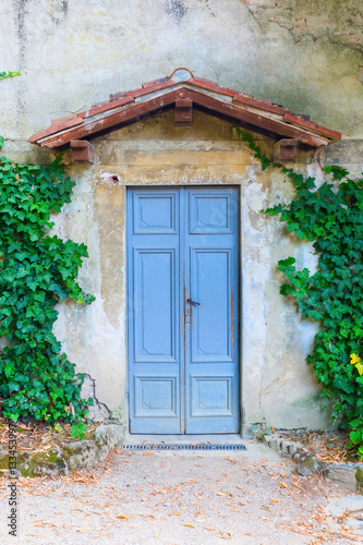 old door with small roof in Tuscany, Italy