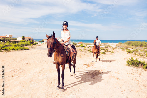 Young Tourist Couple Horseback Riding