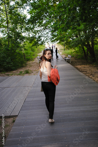 Young girl dressed in casual walking on a street