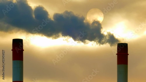 Beautiful sunrise through smokestack emissions in subzero cold Winter air.
