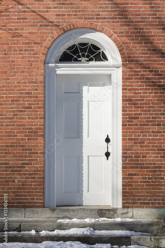 Arched White Door in Red Brick Wall
