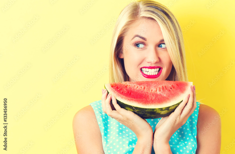 Happy young woman holding watermelon Happy young woman holding watermelon