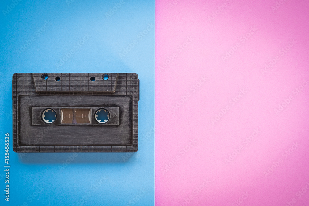 Fototapeta premium cassette tape over paper background, top view