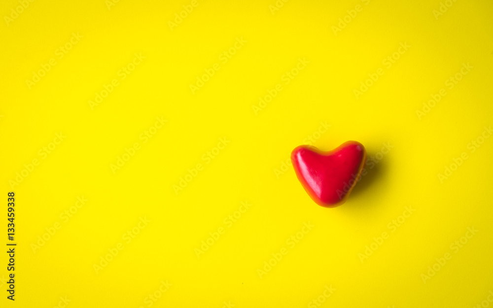 man hands giving red heart on yellow background man hands giving red heart on yellow background