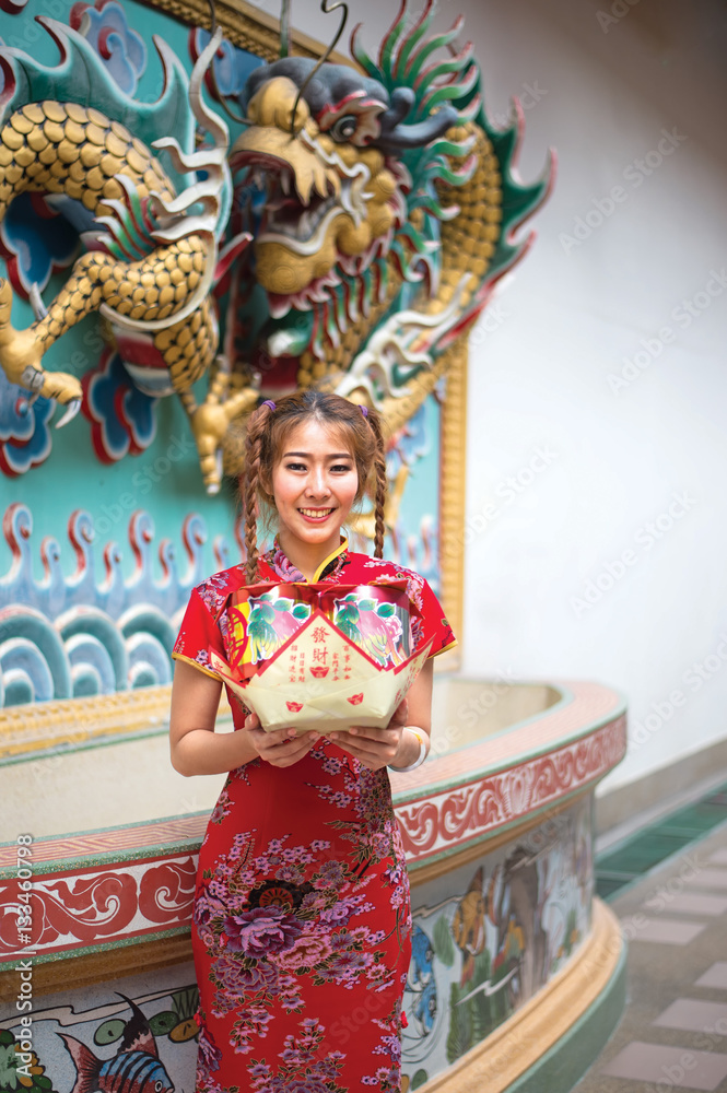 Chinese woman in traditional cheongsam in the new year in the Shrine