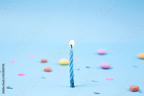 Candles for birthday party on blue background.