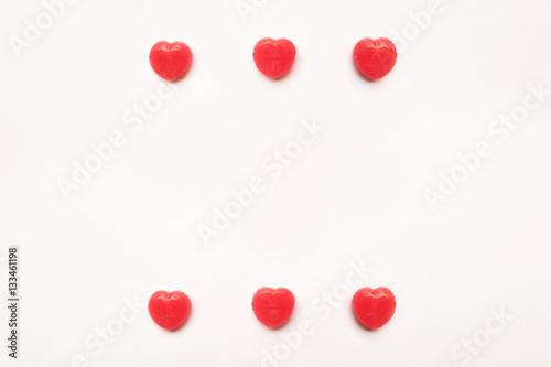 Red Valentine's day heart shape candy pattern on empty white paper background. Love Concept. colorful hipster style. Knolling top view.