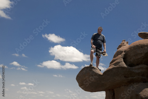 Hiker standing on a rock overlooking the valley